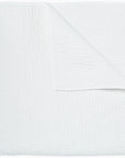 The John Robshaw Hand Stitched Coverlet King, neatly folded with a corner turned down, showcases its soft, lightweight cotton voile and subtle stitched pattern.
