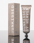 A metallic tube and matching box labeled "Tallow Sunscreen SPF 50" by Faire stand upright on a glossy surface, highlighting this sensitive skin sunscreen against a crisp white background.