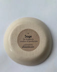 Turning over the Faire Ring Bowl reveals a label with "Sage for longevity, wisdom & protection," sharing its botanical symbolism and website, on a plain white background.
