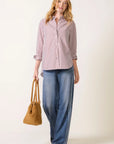 Connie stripe shirt by Rag & bone worn with wide-leg blue jeans and a tan suede handbag.