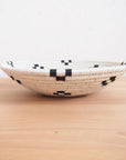 Small bowl with black geometric pattern on light wood surface, Bungalow Furniture & Accessories, Faire Maraba collection.