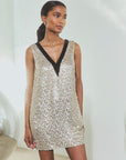 Metallic sequined mini dress with black V-neck trim from Hunter Bell NYC, perfect for holiday celebrations.