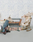 Maileg mouse vacuums in a robe while another reads in a vintage-inspired setting; whimsical decor by Bungalow.