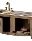 The Maileg Kitchen is a miniature bronze-colored playset with a sink, four-burner stove, opening oven with roast and tray, plus classic faucets—ideal as an accessory for dollhouses or Mouse family homes.
