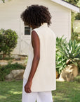 Frank & Eileen Montecito Tank in a casual outdoor setting by a white house with greenery, modeled by someone with curly hair.
