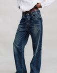 Denimist ALLFIT Jean styled with a white hoodie and sneakers, modern casual look against a plain backdrop.