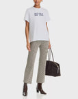 Giovanni tee by Rag & Bone paired with patterned trousers, ankle boots, and a black tote.