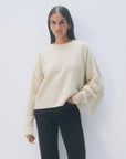 Oversized cream cashmere blend sweater with fringe sleeves paired with black jeans, White + Warren Luxe Fringe Crew.