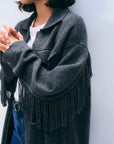 Dark grey White + Warren cashmere blend fringe coat with fringe sleeves worn over a white shirt and jeans.
