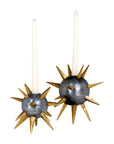 Two white taper candles sit in The Import Collection's Punk Candleholders—gold spike holders with metallic gray spherical bases, resembling sea urchins—for an edgy, industrial decor accent.