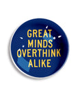 Ben's Garden's Dome Crystal Paperweight features blue and yellow text, "GREAT MINDS OVERTHINK ALIKE," with white accents and stars, inspired by handcrafted New York studio style.