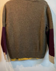 Brown cashmere crewneck sweater with purple and cream color-blocked sleeves by Free City, shown on a hanger.
