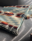 Secoya Throw in vibrant mint with a geometric Southwestern pattern and fringed edge by Bungalow Furniture & Accessories.