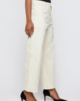 A person models the Pomonok Gusset Cargo wide-leg jeans by Moussy, paired with black pointed-toe heels, standing sideways against a plain light background.