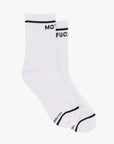 A pair of white "Baby Steps" tube socks by Mother with black trim at the top and the word "MOTHERFUCKER" partially visible in black near the cuff.