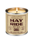 Tin soy candle with Hay Ride label from Faire featuring cedarwood scent, burn time, and weight details.