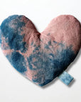 The Faire Heart Eye Pillow, featuring a pink and blue tie-dye cotton design with a small blue fabric loop, provides gentle anxiety relief and is displayed against a plain white background.