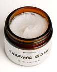 Whipped tallow moisturizer in an open amber glass jar by Faire SC.