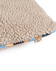 Beige sherpa dog bed with multicolored striped trim and memory foam by Faire in Stone, Large.