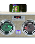 The Faire Gold Bling Wireless Boombox with FM Radio features two round LED speakers—one glowing green, the other red—a digital display, control buttons, and a docked smartphone on top playing music in retro vintage style.