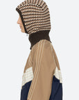 Tan jacket with white stitching and Sea New York DECLAN BALACLAVA, shown in a modern lifestyle setting.