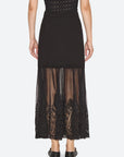 Black ribbed knit maxi skirt by Sea New York featuring a sheer tulle hem with intricate lace embroidery.