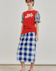 A person wearing a red "I'm a Pepper" T-shirt, a puff-sleeve blouse, an Aquarius Cocktail Le Pencil Slim Skirt in Japanese cotton poplin blue-and-white check, black slip-on shoes, and sunglasses stands against a plain light background.