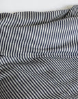 Rumpled Baltic Queen Duvet by Plum Textiles in soft white on bed with matching pillow, cozy bedroom style.