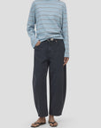 CLOSED Jazzie blue striped shirt styled with barrel-fit denim and black sandals, hands in pockets.