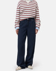 Ivory crewneck longsleeve from CLOSED styled with blue wide-leg jeans and cream loafers, casual modern look.