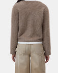 CLOSED crew neck cardigan in beige, shown from the back, paired with wide-leg pants against a plain backdrop.