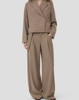 CLOSED cropped blazer and relaxed wide-leg pants in neutral tones, hands in pockets, modern tailored look.