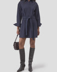 CLOSED organic cotton shirt dress in black styled with knee-high boots and a small black handbag, modern look.