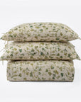 A neatly stacked set features two Millie Euro Shams and a quilt by Amity Home, all with a green and beige solar print floral pattern on soft cotton voile, arranged against a plain white background.