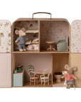 The Maileg SuitCasa Little Sis & Bro by Maileg is a portable mouse house with patterned walls, furnished rooms, two striped-shirt mice, kitchen, dining area, bathroom, bunk bed bedroom, living room, and handcrafted toy accessories.