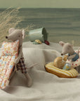 The Maileg Beach Mouse w/ Air Mattress Dad by Maileg features Dad Mouse in plaid shorts with a floral air mattress, ready for beach play. The set includes beach accessories and a sea backdrop for imaginative adventures.