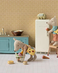 Maileg Little Brother Mouse with Bag in a playful kitchen scene, one cleaning, one at the fridge, food scattered.