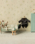 Maileg toy mouse tucked in bed with green wardrobe and accessories, styled in Mouse Hole Farmhouse bedroom setting.
