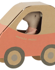 Little sister mouse in a glittery pink polka-dot dress inside a cardboard car by Bungalow Furniture & Accessories.