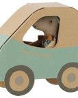 Maileg Little Brother mouse in a bowtie sitting in a light blue and cardboard toy car.