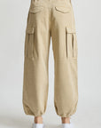Beige Denimist cropped cargo pants styled with white slip-on shoes, shown from the back.