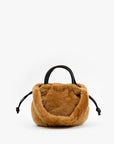 Tan faux fur mini handbag with black leather straps and drawstring ties from Clare Vivier.