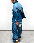 Free City Indigo Workshop Biggy Shirt with tan boots, lifahalove detail, shown on concrete floor at Bungalow Furniture.