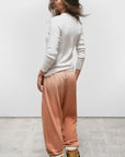 Free City LNL SuperYumm Vintage OG Sweatpant in white with tan boots, casual outdoor setting.