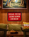 Couch with green pillows in a cozy room, A Faire camp flag above featuring playful text for a relaxed vibe.