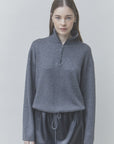 SUNCOO Pristo Knitted Rhinestone Sweater paired with a black skirt, styled against a light background.