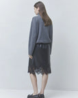 Pristo dark grey high-collar sweater and black lace skirt by SUNCOO, styled with a light background.