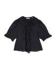 The Henri Top by DOEN is a black, short-sleeved, Edwardian-inspired blouse featuring puffed sleeves, a ruffled lace-trimmed collar and front, and elastic smocked cuffs. Made from lightweight organic cotton voile that's slightly sheer.