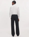 Irina Ponte Track Pant in black worn with a white button-down shirt, back view.