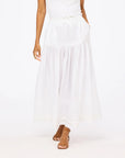 White Kerri Rosenthal Vacance Pintuck Shirt with lace-trim midi skirt and brown heeled sandals in a casual setting.